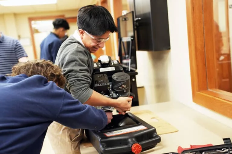 students working on an engine