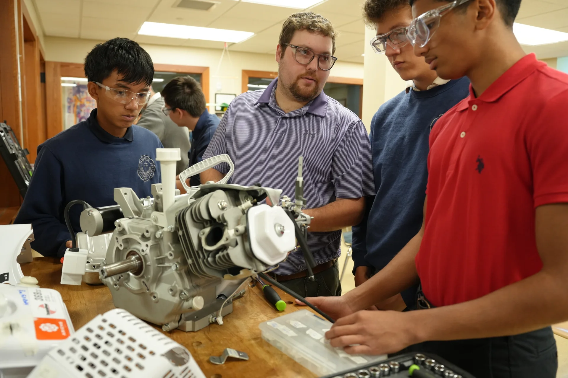 students working on an engine