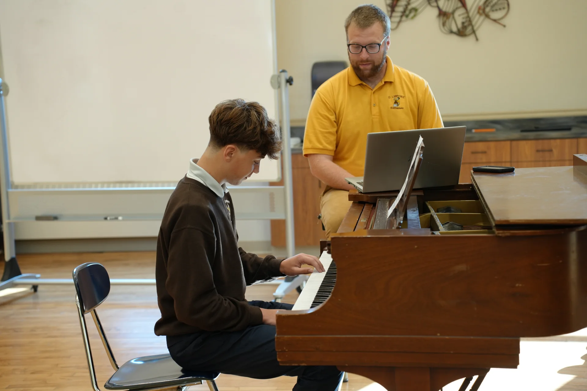 SLS student learning to play piano