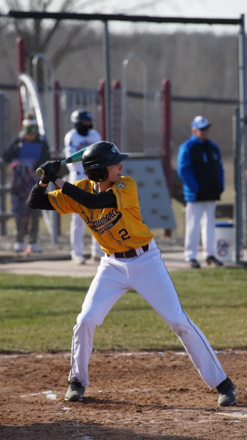 baseball team sitting on bleachers