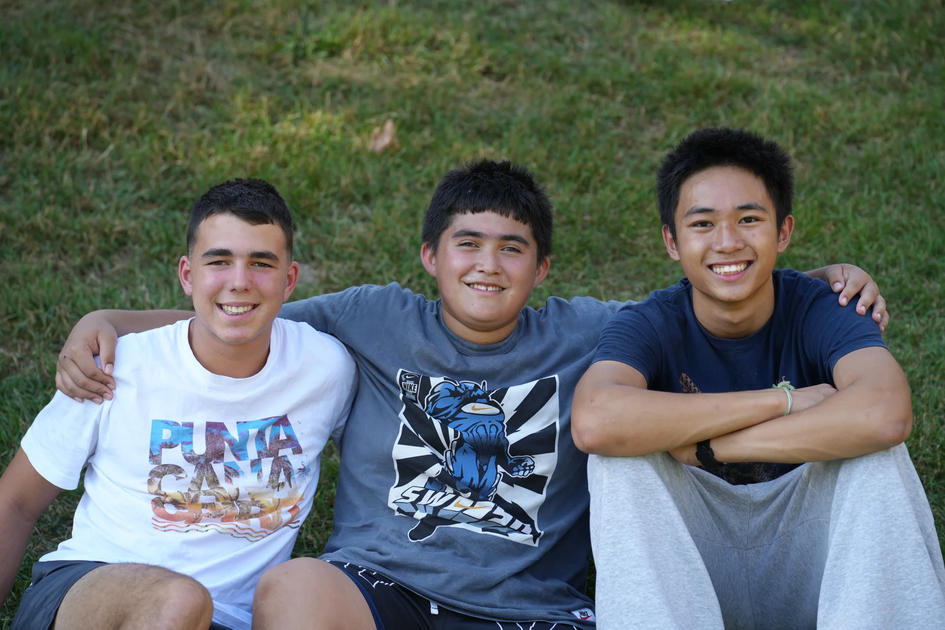 three boys smiling at SLS